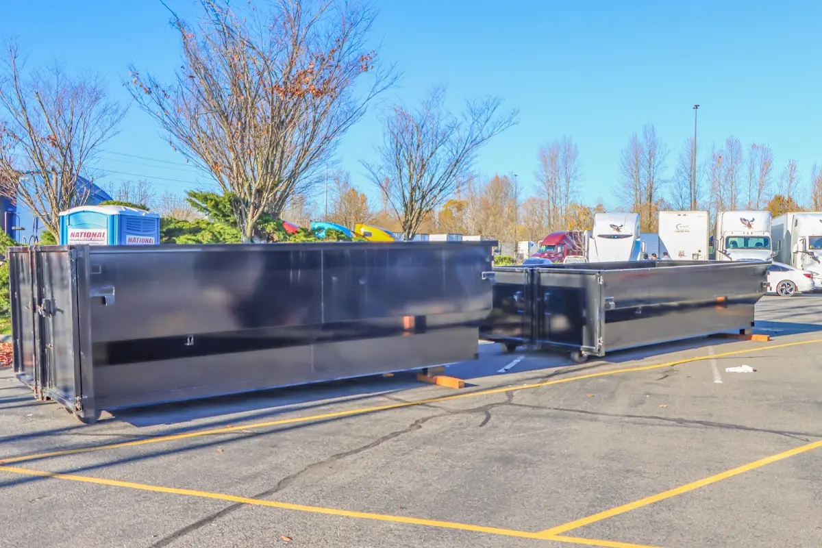 Professional dumpster rental service with roll-off container on residential driveway in Banning